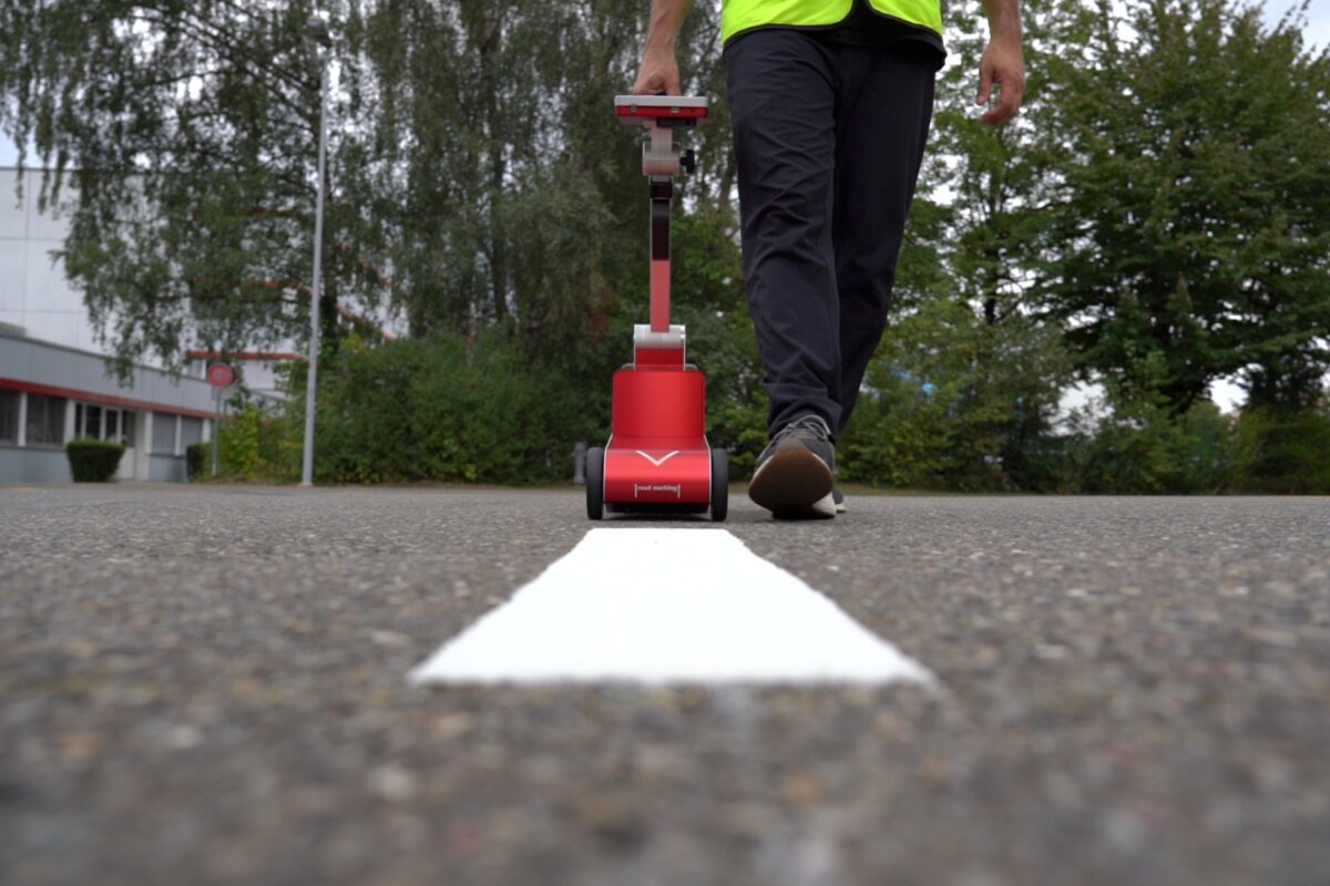 Field technician on a road with equipment case