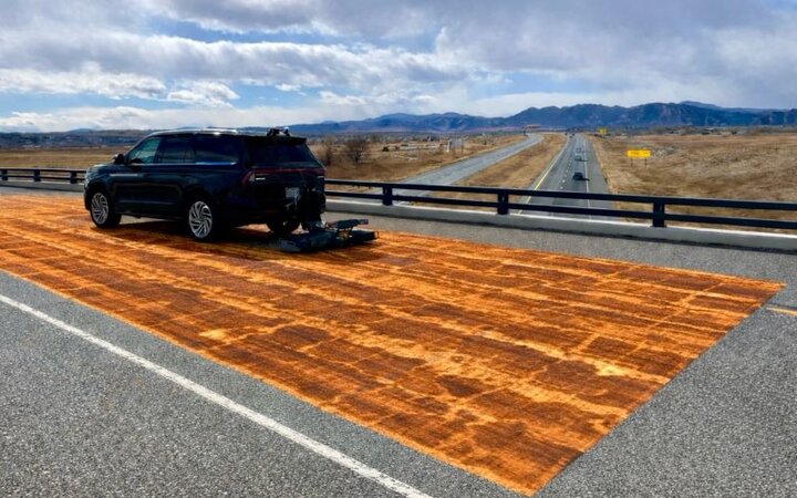 GPR survey vehicle scanning a bridge deck, subsurface scan heatmap overlaid on the roadway